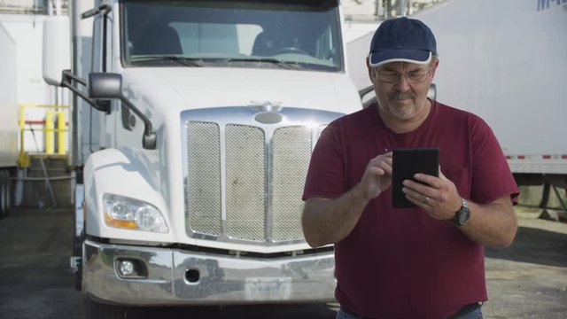 Truck driver using digital tablet.  Fully released for commercial use.