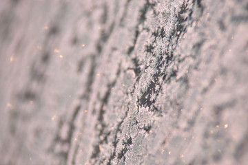 Pattern on glass. White color. Snowflakes. Brilliant texture