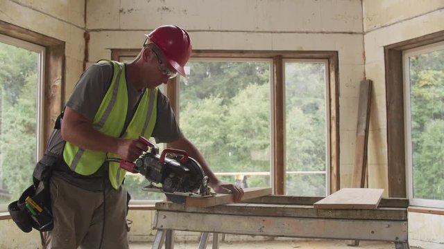 Construction worker cutting board with circular saw