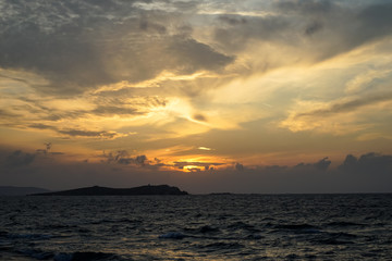 Beautiful shades of soft pastel orange and blue sunset color sky and abstract cloud background with windy wavy seaview
