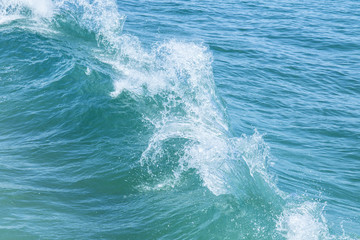 Two waves collide off a of a tropical island