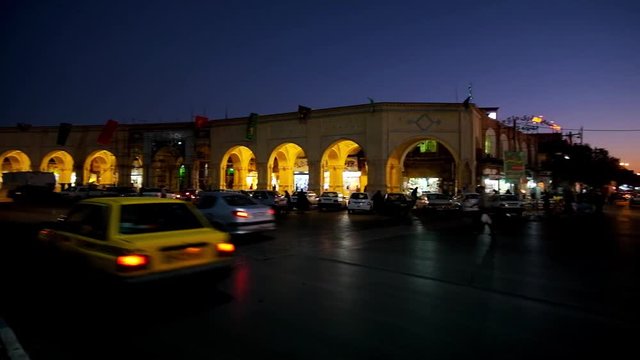 Heavy traffic in Shohada square with a view on pavilions of Ganjali Khan Bazaar in evening illumination, Kerman, Iran