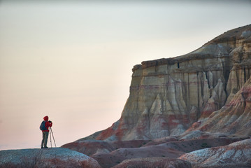 A photographer taking pictures in colorful Mongolian canyons