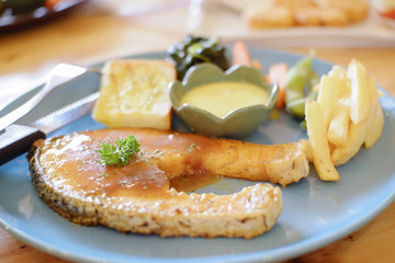 Salmon steak, french fries, sauce