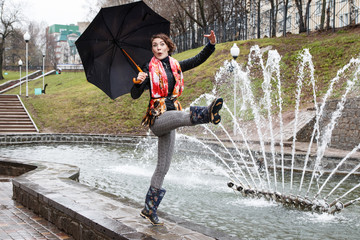 Girl with umbrella outdoor in a rain day