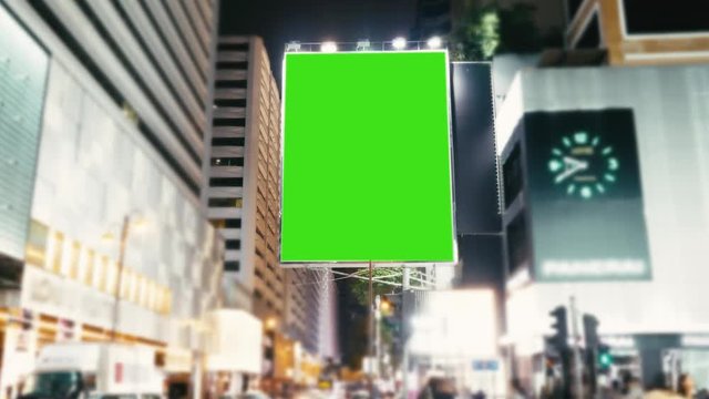 A Billboard with a Green Screen on a Evening Streets of Hong Kong .Time Lapse 