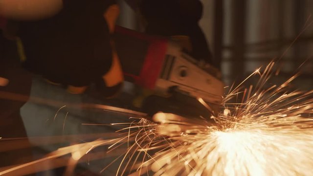 Construction worker grinding metal, closeup