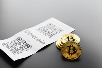 Bitcoin golden coins and paper receipt
