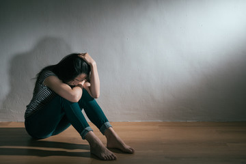 Fototapeta na wymiar depression sadness woman sitting on wooden floor