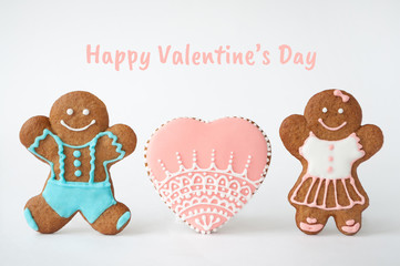 Happy Valentine`s day. Homemade gingerbread man. Boy, girl and heart. Concept of love. Picture for a menu or a confectionery catalog. Invitation or greeting card with copy space.