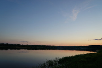 sunset over a lake in forest
