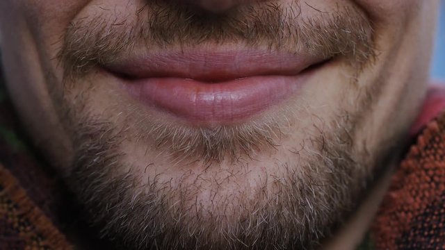 Close up of male lips smiling to camera 