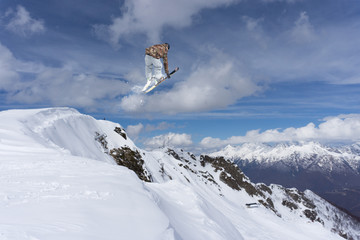 Naklejka na ściany i meble Skier jump in the mountains. Extreme ski sport. Freeride.
