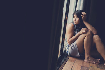 Fototapeta na wymiar woman feeling sad at window . Lonely. Broken heart. woman unhappy. fell sick. sad girl