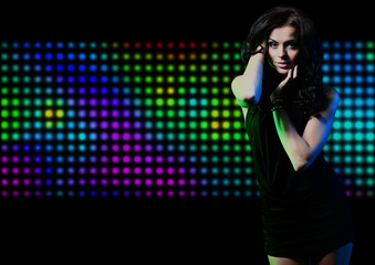 Fashion expressive girl dancing at disco light.
