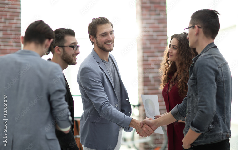 Poster handshake partners in the creative office.