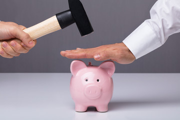 Businessman's Hand Saving Piggybank