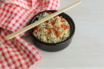 Instant noodles  and chopsticks on wooden table with copy space. Traditional Asian  food.