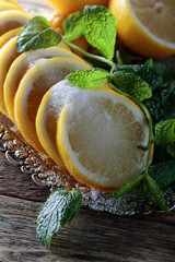 Lemon slices with sugar and mint leaves.