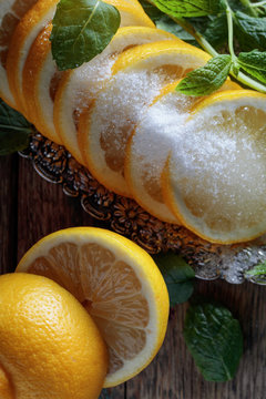 Lemon slices with sugar and mint leaves.