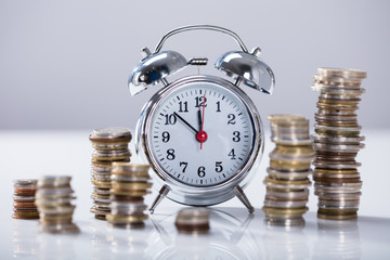 Alarm Clock With Stack Of Coins
