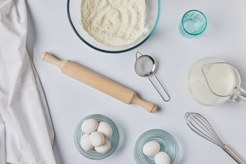 top view of ingredients for dough and tablecloth on table