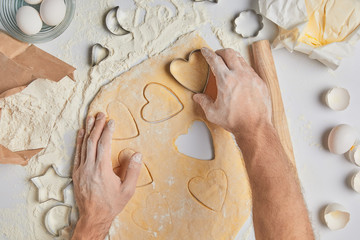 cropped image of chef preparing heart shaped cookies, valentines day concept
