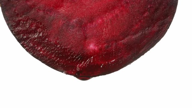 beetroot with dripping clear juice on white background