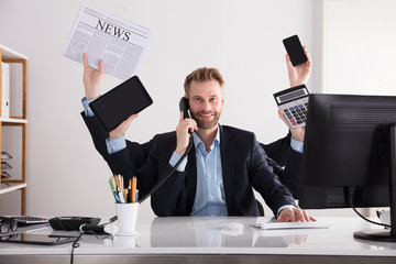 Businessman Multitasking In Office