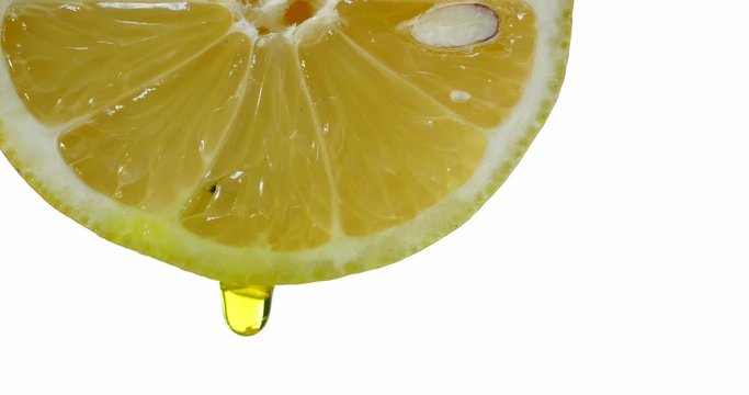 citron with dripping clear juice on white background
