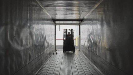 Forklift driving into semi truck trailer.  Fully released for commercial use.