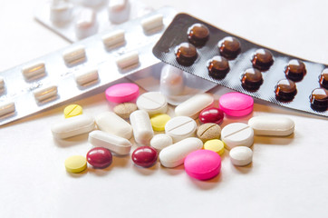 Close-up of the pills on the white background, The drug and capsule pills on the floor, Pile of the drug and pills on the white background.