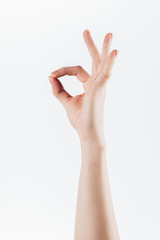 cropped shot of woman showing okay sign isolated on white