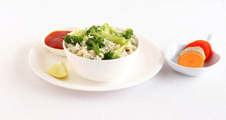 Broccoli rice, a healthy vegetarian food, with tomato ketchup as a side dish and salad.