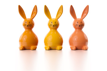 three orange easter bunny figures