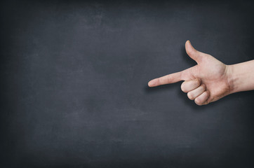 Finger pointing at the blank blackboard