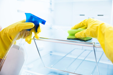 Woman's Hand Wearing Yellow Gloves Cleaning Open Refrigerator