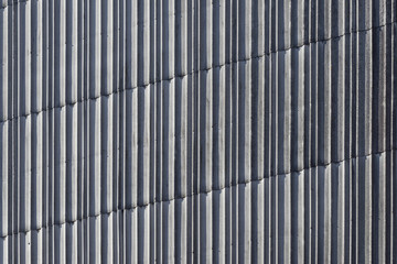 Backgrond image of sheets of aluminum on a wall.