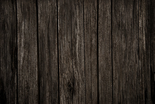 Old rich dark wood grain texture background with knots.