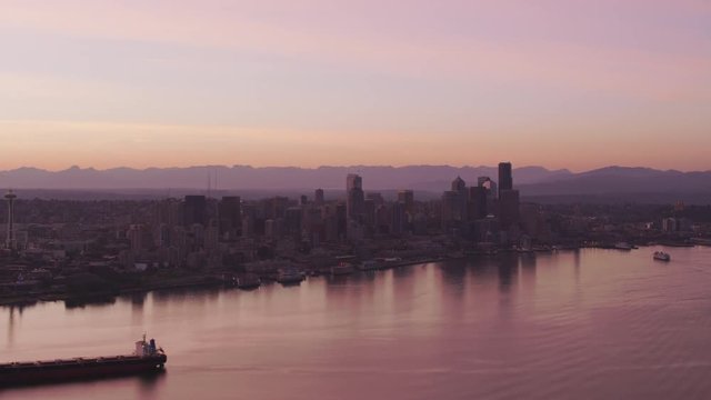 Seattle, Washington circa-2017, Aerial view of ship in front of Seattle skyline at sunrise.  Shot with Cineflex and RED Epic-W Helium. 