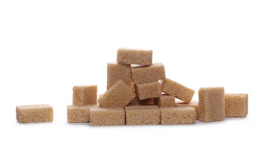 Brown cane sugar cubes isolated on white background