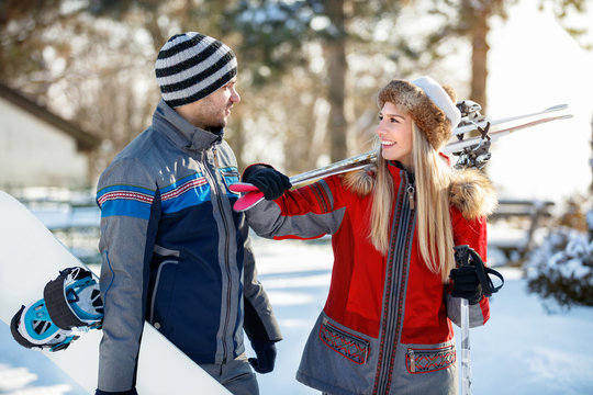 Man and woman in love with ski equipment