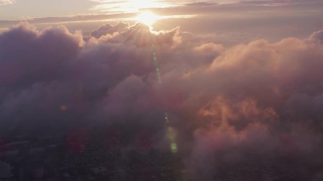 Aerial view of sunrise over clouds with Manhattan below
