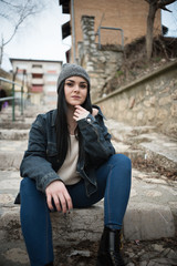 young woman sitting on steps outdoor 
