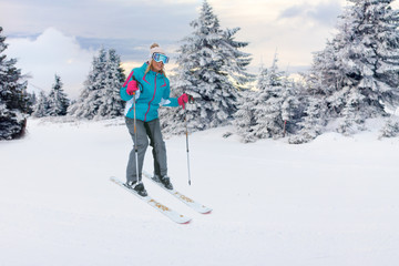 Fototapeta na wymiar girl skiers on the slope at ski resort in the mountain