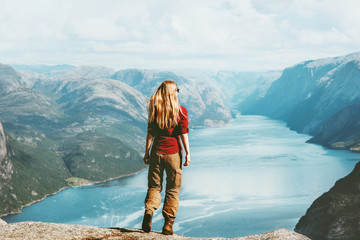 Woman traveler sightseeing Lysefjord landscape Travel Lifestyle concept adventure outdoor active summer vacations in Norway tourist alone