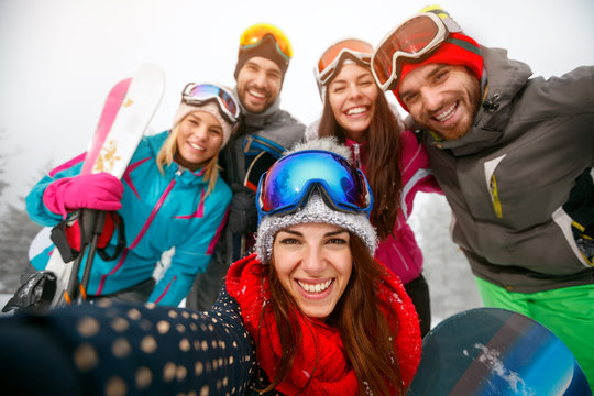 Group of friends having fun on winter hodays and making selfie