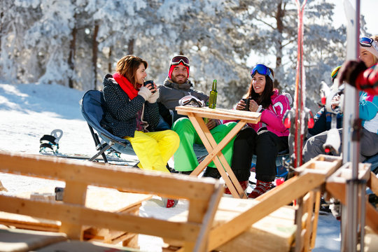friends spending time together in cafe at ski resort