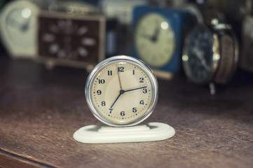 Retro alarm clocks on the table. Photo in retro color image