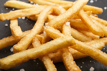 french fries with coarse salt on slate